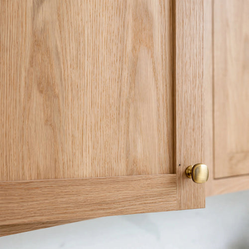 Close-up of slim shaker cabinet door in White Oak with brass knob